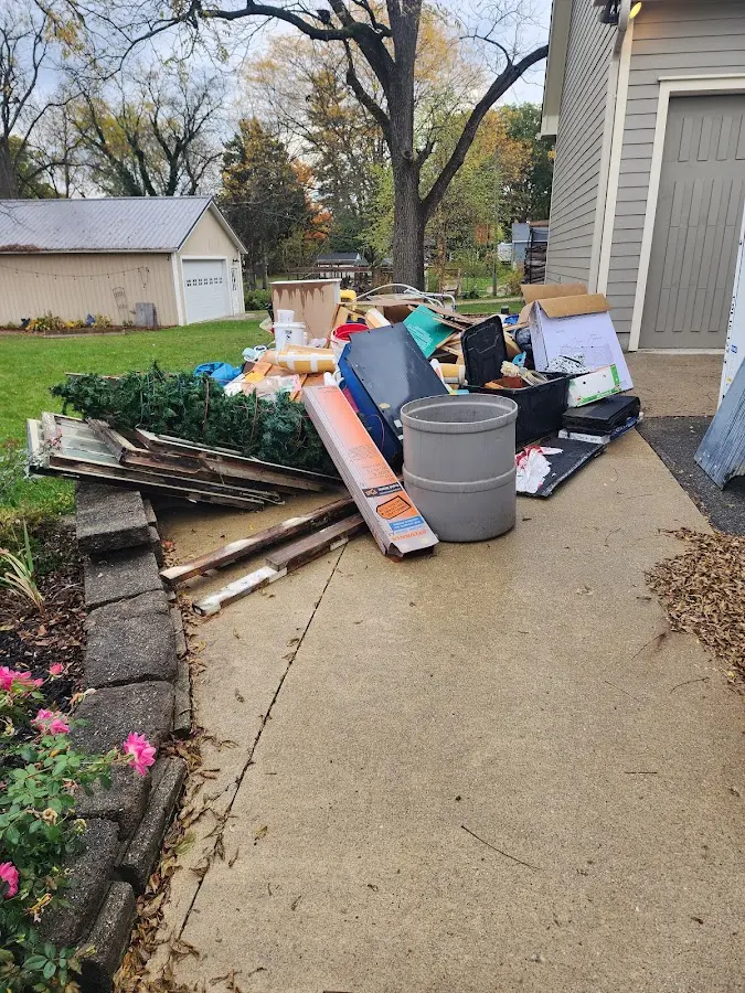 Dumpster being loaded with debris for Demolition Dumpster Rental in Wayland